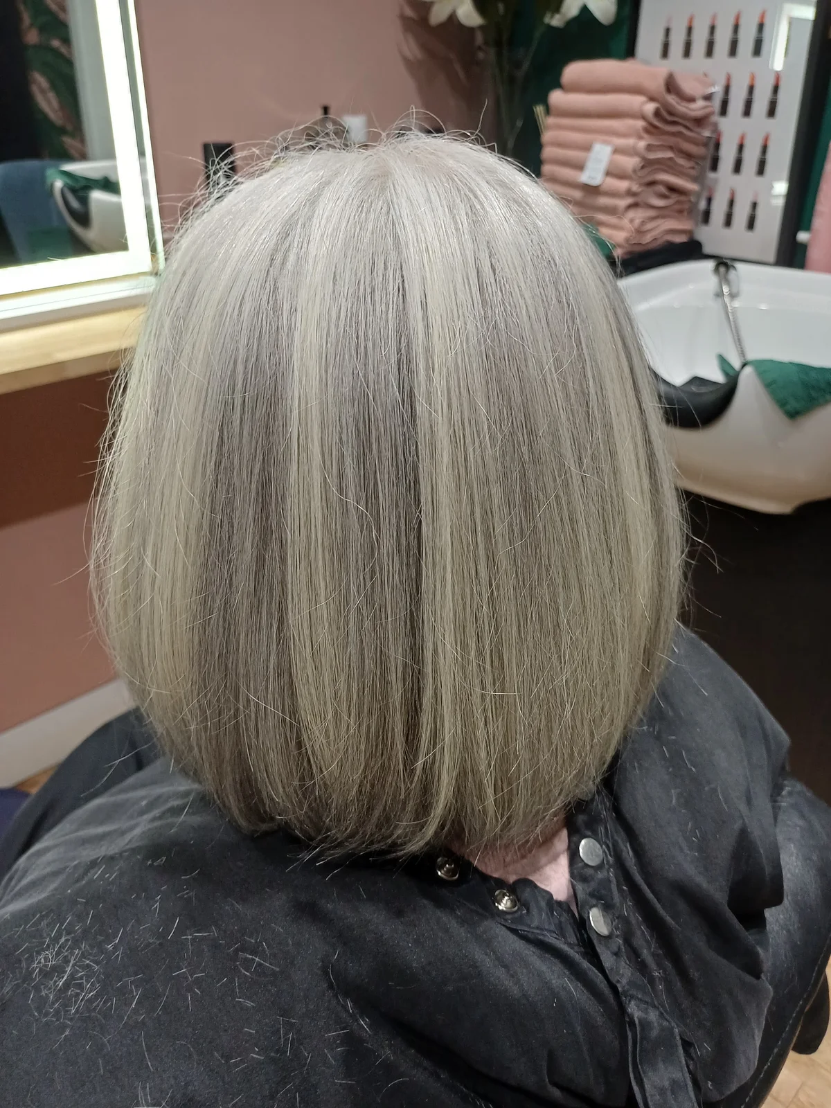A straight silver hairstyle, freshly finished in the salon